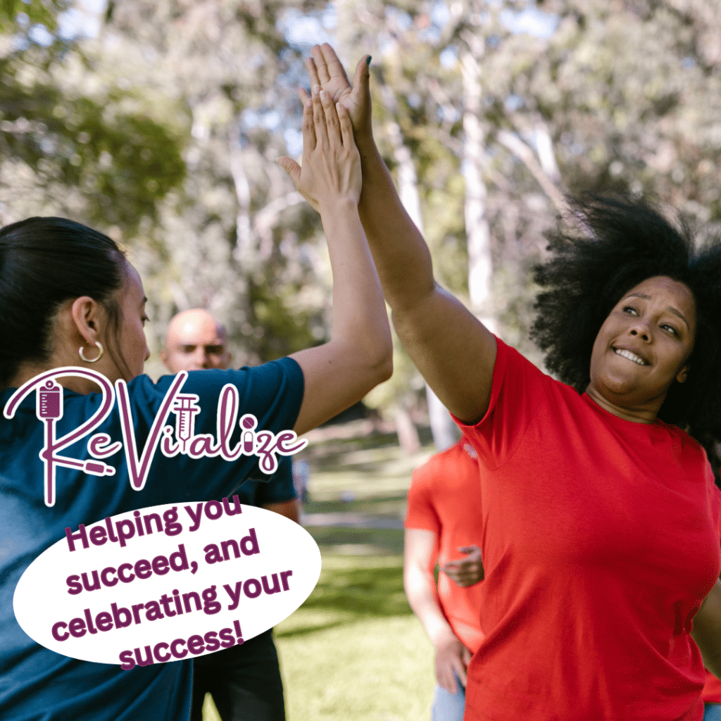Two women celebrating their success with medical weight loss with a high-five with the text "ReVitalize. Helping you succeed and celebrating your success"