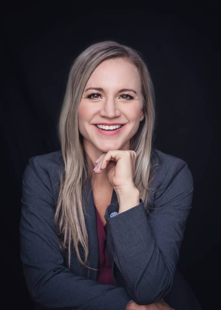 Headshot of Erin Renak, a Physician Assistant who provides medical weight loss services in Idaho for ReVitalize. She is smiling and wearing a grey suit blazer