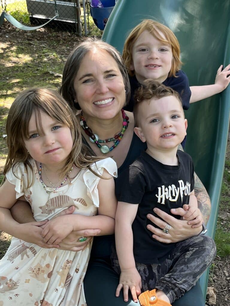 IMG_0452 Marlie Schmidt, PA-C, medical weight loss provider with 16 years experience as a PA is pictured in a casual setting with her 3 young children around her smiling.